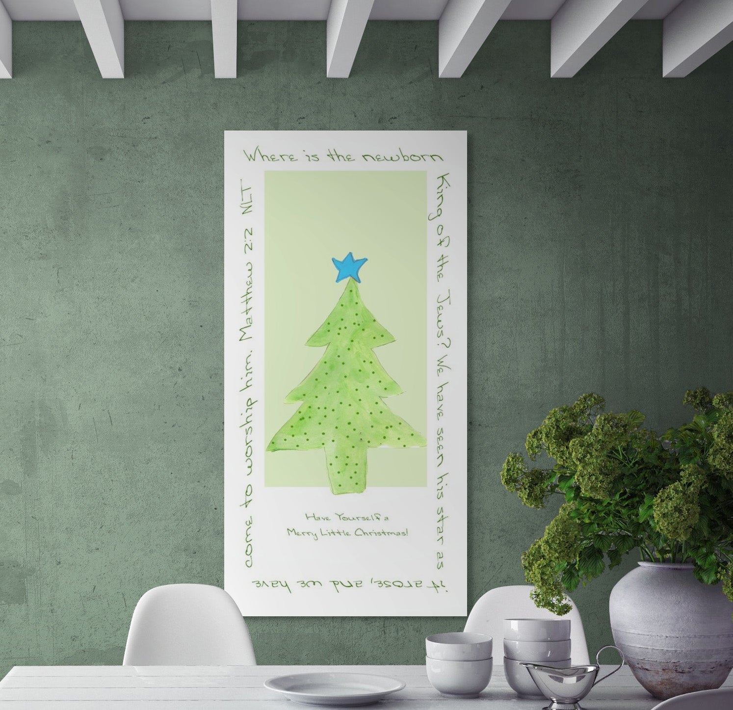 Decorative Christmas tree wall art on a green wall with a table and chairs in the foreground.