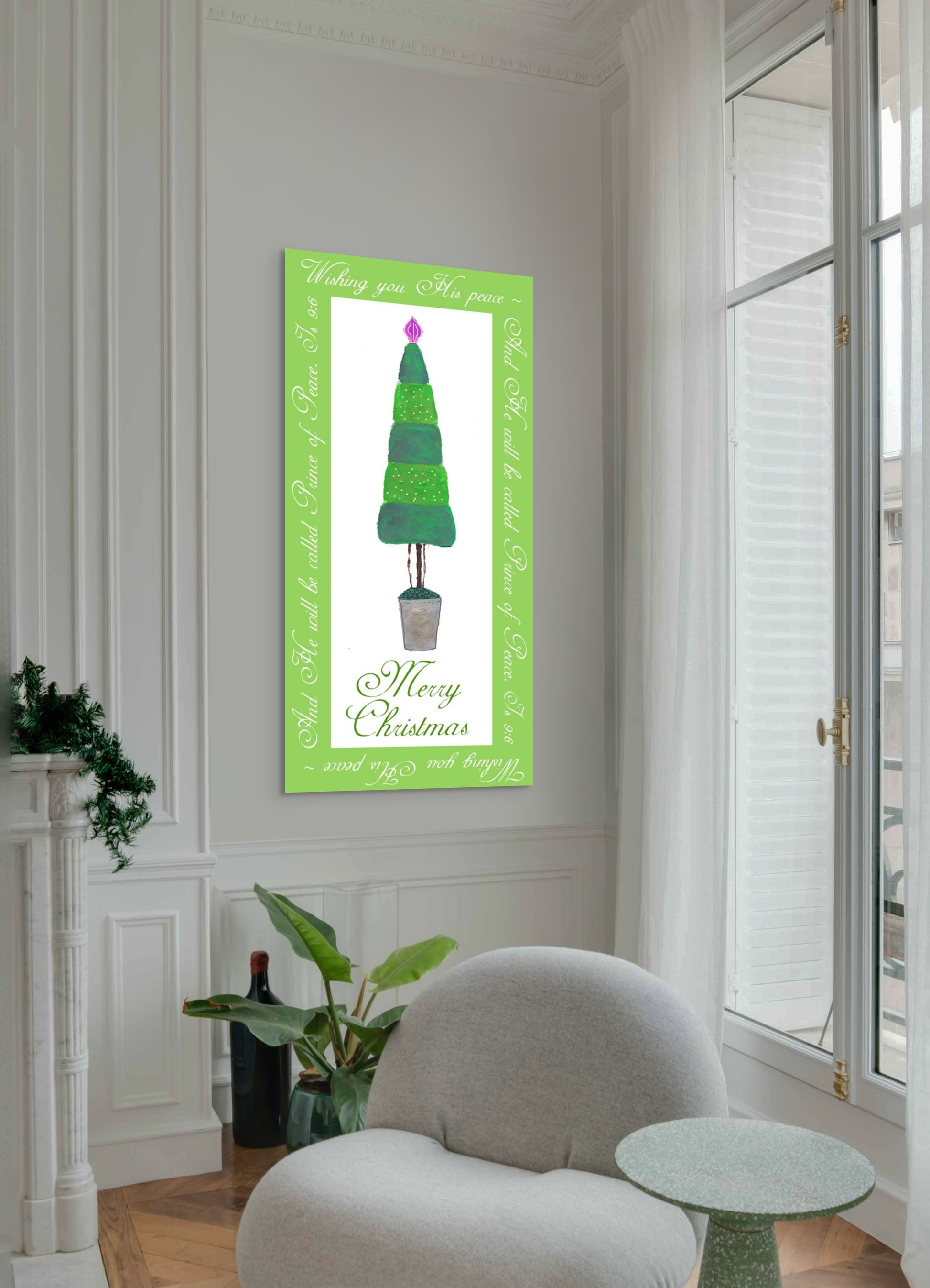 Framed Christmas tree artwork on a wall in a room with a chair and plants.