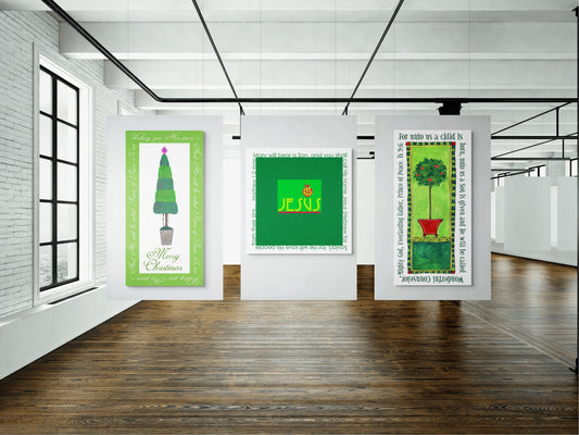 Three Christmas artworks on a white wall in a room with wooden flooring and large windows.